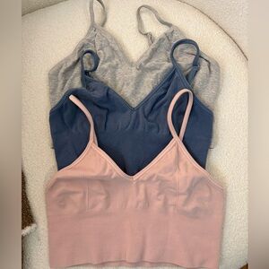 alo yoga delight bralettes in pink, blue, and gray